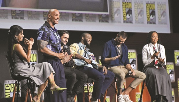 Actor Dwayne Johnson, with cast members, presents his film Black Adam during the Warner Bros. panel at  Comic-Con in San Diego, California yesterday. (AFP)