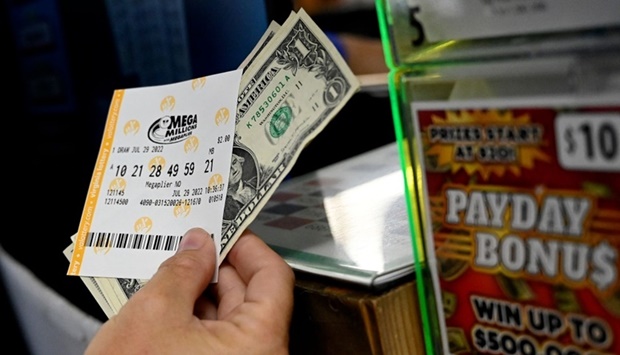 A person buys a Mega Millions lottery ticket at a store on yesterday in Arlington, Virginia. AFP