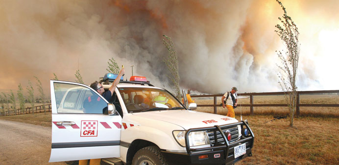 A file photo taken on February 7, 2009, of a Country Fire Authority staff member monitoring a giant fire raging in the Bunyip State Park near Labertou