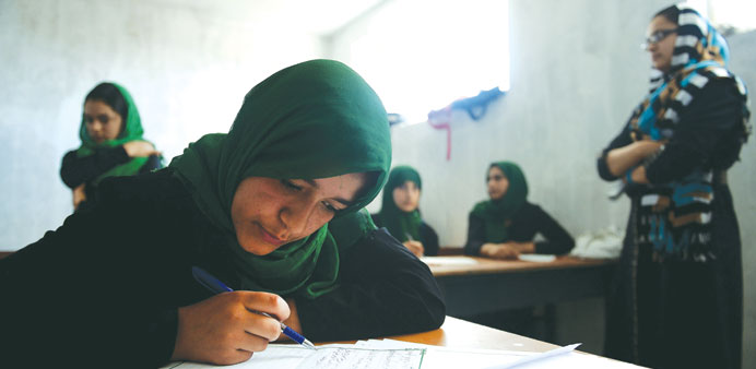 Afghan schoolgirls study during a lesson in the village of Dah Yaya in Dih Sabz District of Kabul province. 