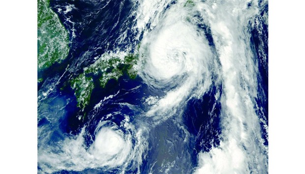 This Nasa satellite image shows Typhoon Mindulle (top) over Japan. A powerful typhoon struck near Tokyo yesterday, the first in 11 years to come ashore in the densely populated region, temporarily shutting down a major city airport and grounding more than 500 flights nationwide.