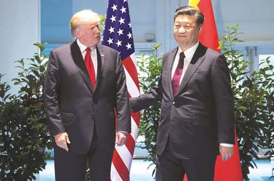 US President Donald Trump (left) and Chinese President Xi Jinping meet on the sidelines of the G20 Summit in Hamburg, Germany (file). The bilateral US trade deficit with China reached $350bn in 2016, and Trump has repeatedly blamed Chinese imports for gutting employment in sectors such as steel.