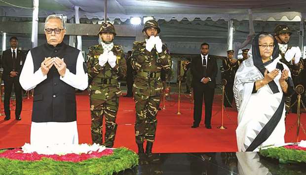 The president and prime minister praying after laying wreaths at a memorial to Bangabandhu Sheikh Mujibur Rahman at Dhanmondi in Dhaka on Tuesday.