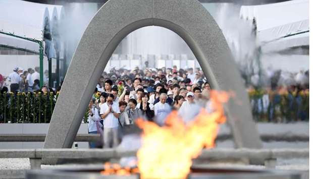 People pray for atomic bomb victims in front of the cenotaph for the victims of the 1945 atomic bombing, at Peace Memorial Park in Hiroshima, western Japan. Reuters.