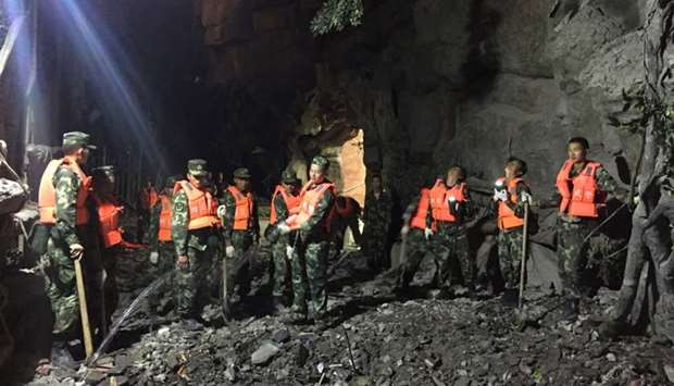 Chinese paramilitary police search for survivors after an earthquake in Jiuzhaigou county, Ngawa prefecture, Sichuan province, China