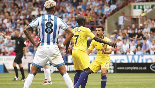 Chelseau2019s Nu2019Golo Kante (centre) and teammate Pedro (right) celebrate a goal during their Premier League match against Huddersfield Town at John Smithu2019s Stadium yesterday. (Reuters)