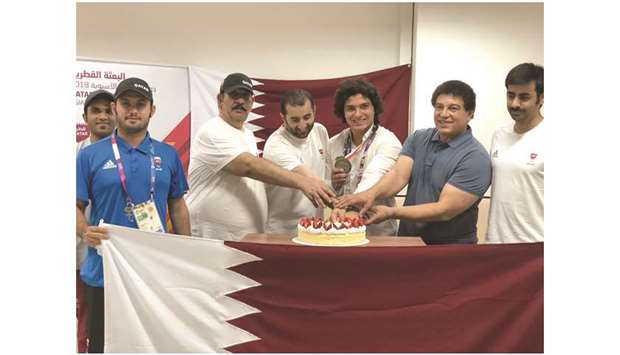 Fares Ibrahim (third from right) celebrates his silver medal with members of Team Qatar yesterday.