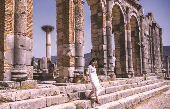 A tourist walks through the ruins of the ancient Roman site of Volubilis, near the town of Moulay Idriss Zerhounon in Moroccou2019s north central Meknes region.