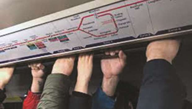 FILE PHOTO: People crowded on a Central Line tube underground train during rush hour commute in London.