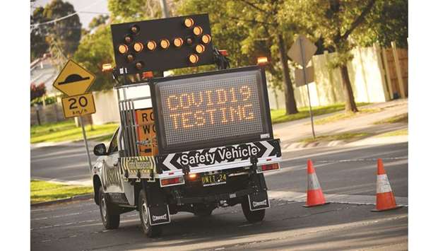 A sign points towards the entrance of a coronavirus disease drive-through testing facility in Melbourne, Australia.