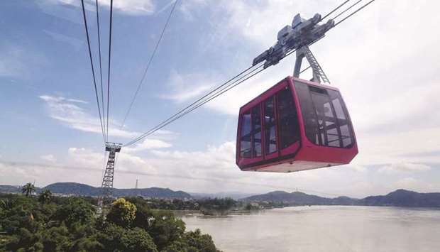 People travel on a cable car cabin in Indiau2019s longest river ropeway which connects the northern and southern banks of the Brahmaputra river during its inauguration, in Guwahati yesterday.