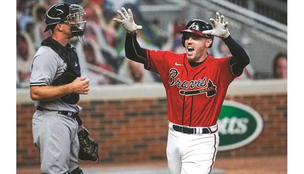 Dansby Swanson of the Atlanta Braves reacts as he crosses the plate