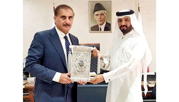 Pakistan ambassador Syed Ahsan Raza Shah receiving a token from entrepreneur/philanthropist Farhan al-Sayed during a recent meeting held at the embassy.