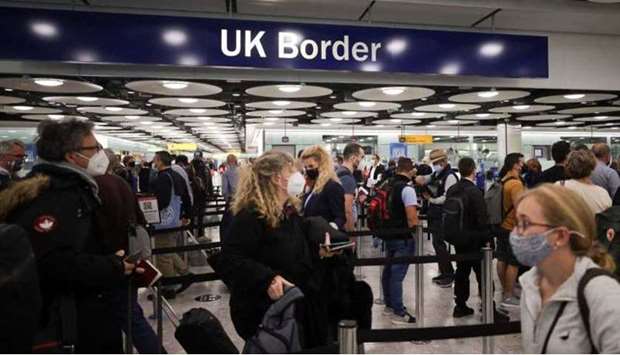 Arriving passengers queue at UK Border Control at the Terminal 5 at Heathrow Airport in London, Britain June 29, 2021. REUTERS