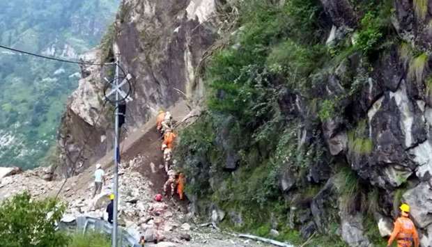National Disaster Response Force personnel are seen during rescue operations at the site of a landslide at the Reckong Peo-Shimla Highway in Kinnaur District in Himachal Pradesh, India. (AFP)