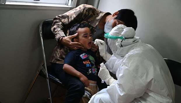 A child is tested for the Covid-19 coronavirus in Banda Aceh on August 13, 2021.rn