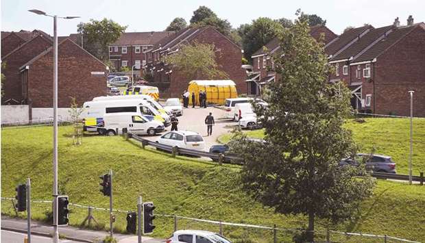 Police officers work at the scene of a shooting incident in Plymouth, southwest England, yesterday.