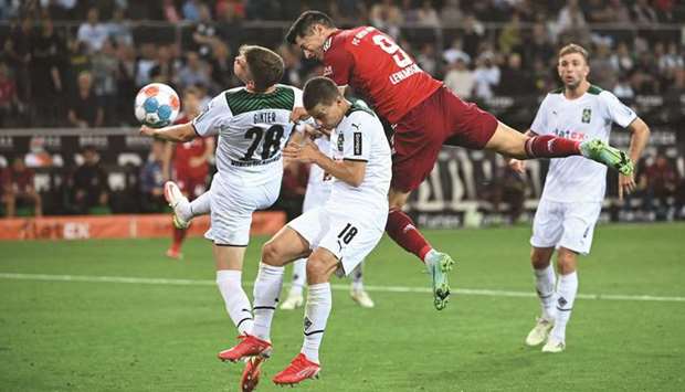 Bayern Munichu2019s Robert Lewandowski (second from right) fights for the ball with Moenchengladbachu2019s Matthias Ginter (left) and Stefan Lainer during the Bundesliga match in Moenchengladbach, Germany, yesterday. (AFP)