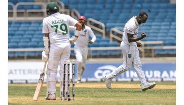 Kemar Roach (right) of West Indies celebrates the dismissal of Azhar Ali (left) of Pakistan during Day 3 of the 1st Test at Sabina Park, Kingston, Jamaica, yesterday. (AFP)