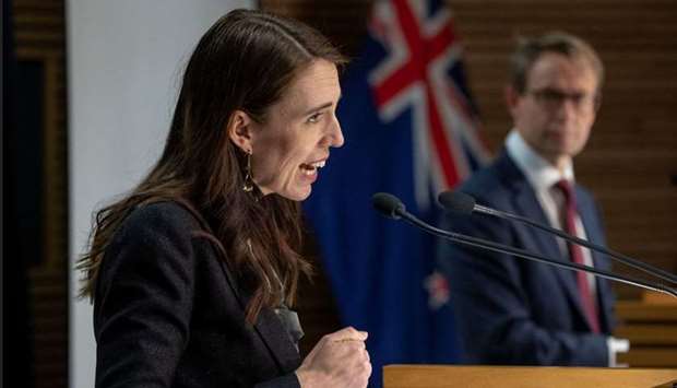 New Zealand's Prime Minister Jacinda Ardern (L) speaks next to Ashley Bloomfield (L), chief executiv