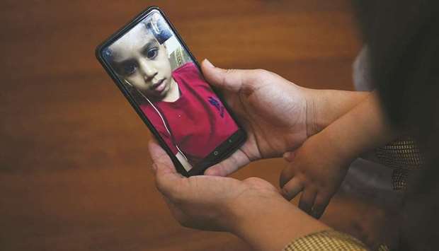 ORDEAL: An Afghan refugee, Maryam, talks via video call to her six-year-old son as he stays in Uzbekistan after she was evacuated from Kabul with the help of the French authorities, in Paris. Maryam and her son were separated during the evacuation but her husband managed to flee with him to Uzbekistan. (AFP)