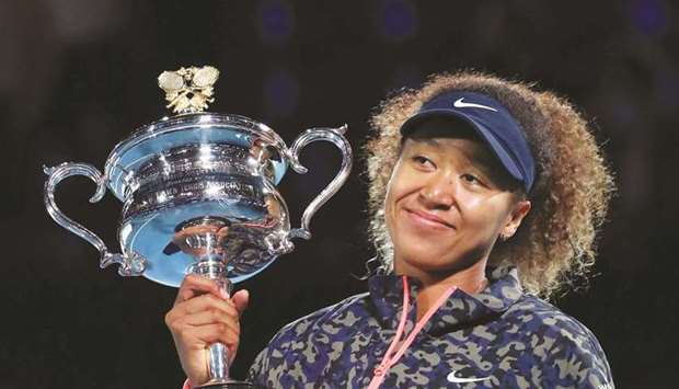 Japanu2019s Naomi Osaka celebrates with the Australian Open trophy in Melbourne on February 20, 2021. (Reuters)