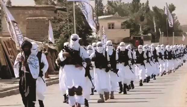 Taliban fighters march in uniforms on the street in Qalat, Zabul Province, in this still image taken from social media video uploaded on August 19, 2021 and obtained by Reuters.