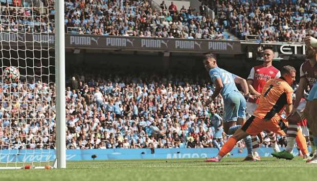 Manchester Cityu2019s Ferran Torres (left) scores their fifth goal during the Premier League match against Arsenal at Etihad Stadium in Manchester, England, yesterday. (Reuters)