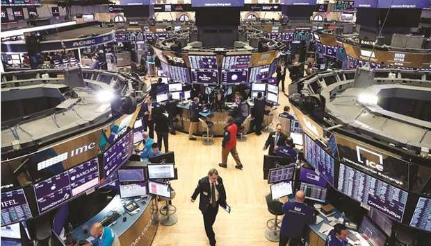 Traders work on the floor of the New York Stock Exchange (file). A rally in which US stocks have doubled from post-pandemic lows is about to enter the yearu2019s worst month for equities, as investors focus on a nationwide Covid-19 resurgence and how quickly the Federal Reserve plans to pull back on its easy money policies.