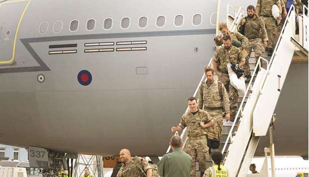 Military personnel arrive at RAF Brize Norton base after being evacuated from Afghanistan, in Oxfordshire, Britain, yesterday.