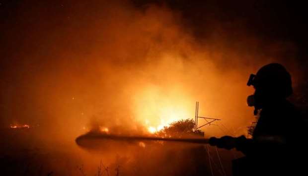 A firefighter battles a wildfire near Afidnes, north of Athens, Greece on Thursday. REUTERS