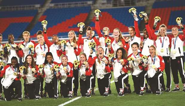 Canadau2019s football team pose with the gold medals at the Tokyo 2020 Olympic Games in Yokohama yesterday. (AFP)