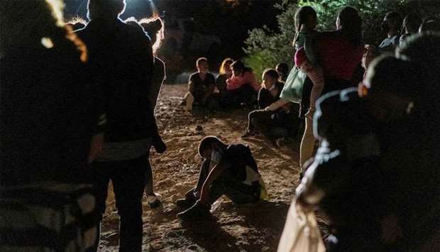 (File photo) Asylum-seeking migrant families from Central America wait to be processed by the U.S. Border Patrol agents after crossing the Rio Grande river into the United States of America from Mexico in Roma, Texas, US, recently. (REUTERS)