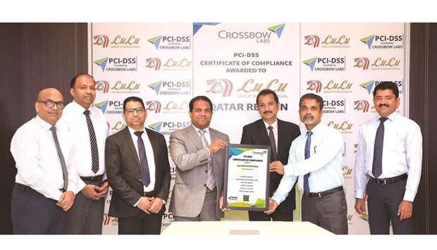 Dr Mohamed Althaf, director of LuLu Group International, and other officials with the certification.