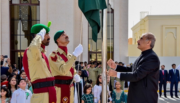 Ambassador Syed Ahsan Raza Shah hoisting the Pakistani flag at the embassy premises.