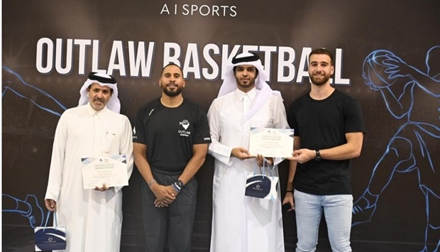 Qatar basketball player and Founder & CEO of A I Sports Abdulrahim Abuissa (right), Cleveland Cavaliers assistant coach JJ Outlaw (second left) pose with Qatar Basketball Federation president Mohamed al-Mughaiseeb.