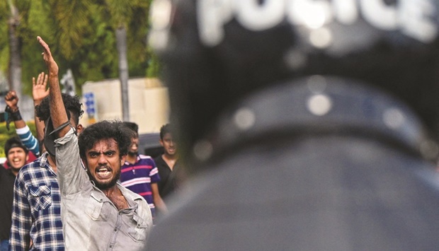 Sri Lankan university students take part in a demonstration in Colombo on Thursday. Sri Lanka police fired tear gas and water cannon to break up the first demonstration since the crisis-hit island nation lifted a state of emergency. (AFP)