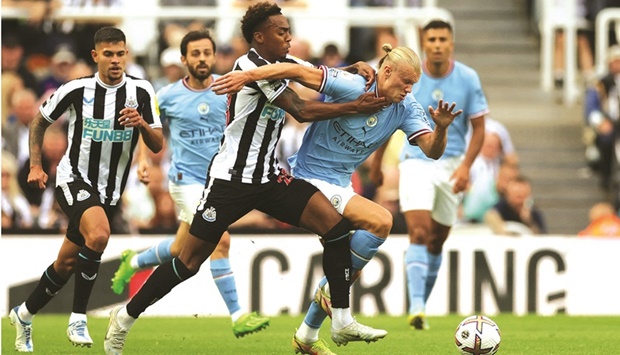 Newcastle Unitedu2019s Joe Willock and Manchester Cityu2019s Erling Haaland vying for the ball during their Premier League match at the St James Park in Newcastle, Britain, yesterday. (Reuters)