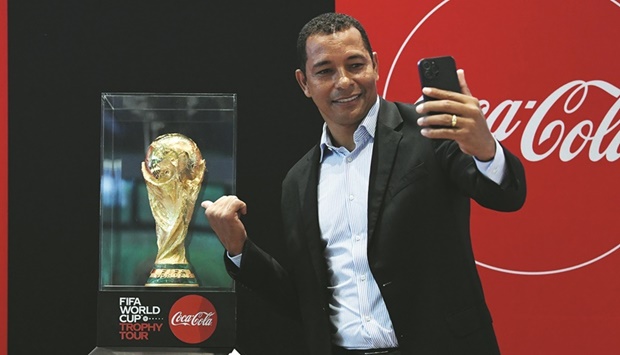 Brazilu2019s World Cup winner Gilberto Silva poses with the trophy.