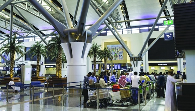 Passengers queue at the airline check-in desks inside the passenger terminal at Muscat International Airport in Oman. Amid signs of improvement due to strong pent-up demand, the Middle Eastu2019s aviation industry still faces strong headwinds, including geopolitical instability in Eastern Europe and its subsequent impact on the global macroeconomics.