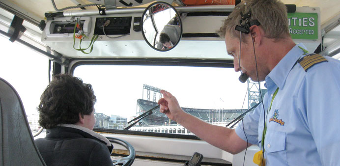 HANDS-ON: A youngster gets a view from the driveru2019s seat on the DUKW u201cducksu201d boat tour in San Francisco.
