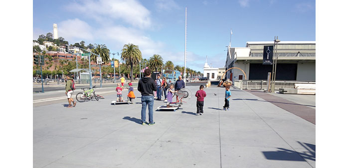 GOOGLE GLASS: Outside San Franciscos Exploratorium on Pier 15, kids work a bike-like wheel called a Bicycle Rope Squirter. The image was taken with Go
