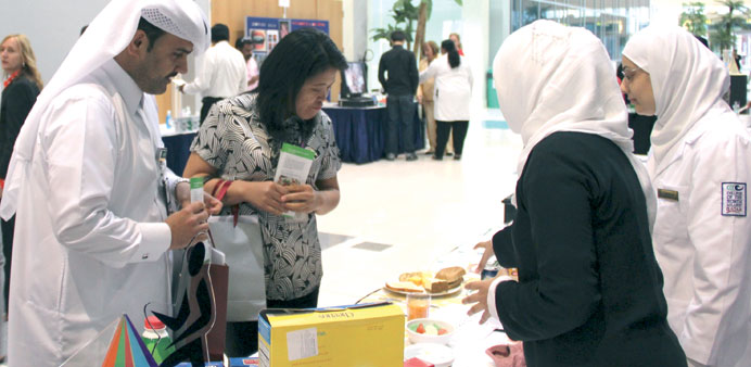 (Above) Dr al-Emadi visits one of the tables; (right) Dr al-Emadi and MacLeod at the launch of the programme.
