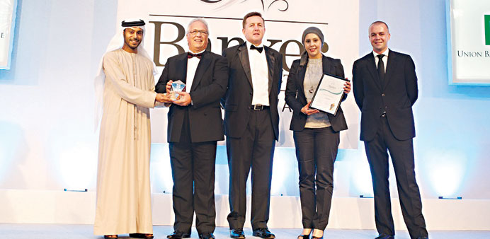 Gary Mond, head of personal banking at al khaliji, receiving the award. He is accompanied by Wessam Mohamed Labib, senior manager for Premium Banking,