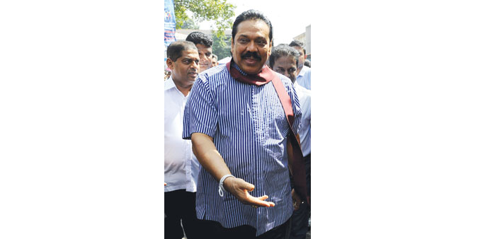 Mahinda Rajapakse gestures at a free medical clinic organised to drum up support for him during re-election campaign in January 8.