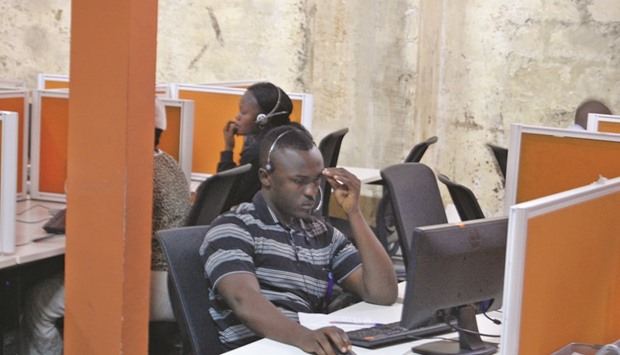 Congolese agents sit in their cubicles as they speak on the phones with their clients, inside the Congo Call Centre (CCC) in the Democratic Republic of Congou2019s capital Kinshasa on July 26. Serving companies, aid agencies and even churches, the CCC handles queries from 8,500 people each day on everything from problems with phone bills to spiritual anxiety and domestic abuse or sexual violence.