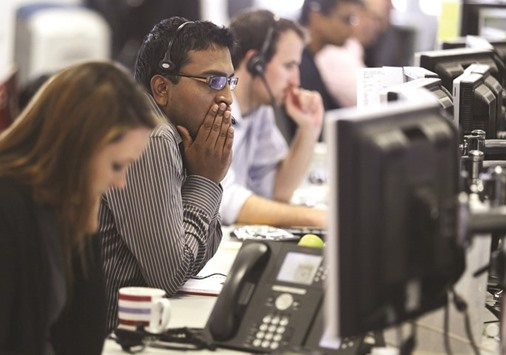 A dealer reacts on the trading floor at financial spread betting company IG Index in the City of London (file). London shares closed up 1.1%, mining giant Glencore leading the way with a 5.5% rise.