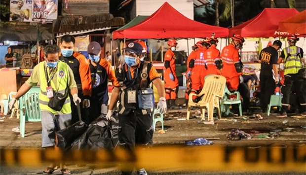 Rescue workers after an explosion at a night market in Davao City