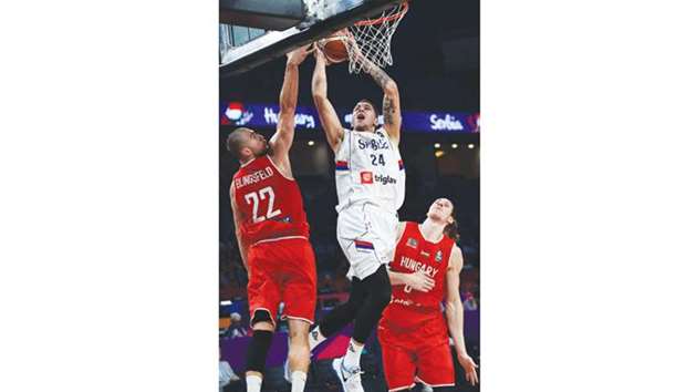 Serbiau2019s guard Stefan Jovic (C) tries to score a basket against Hungaryu2019s Akos Keller (R) and Janos Eilingsfeld (L) during the FIBA Eurobasket match in Istanbul yesterday. (AFP)