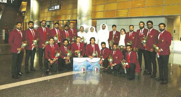 Qatar cricket team players and officials pose at the Hamad International Airport in Doha yesterday after their return from the ICC World Cricket League Division 5 tournament, where they finished third, in South Africa recently. PICTURES: Anas Khalid